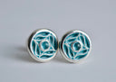 Pair of silver earrings with blue enameled design on a gray background