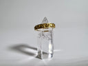 Clear crystal with a gold band on a gray background