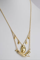 Gold necklace with pendant on a mannequin