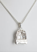 Silver pendant necklace with 'HOROMA' engraving on a light gray background