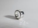 Silver ring on a gray background