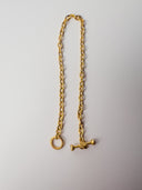 A 24k gold bracelet with a diamond toggle on a white background.